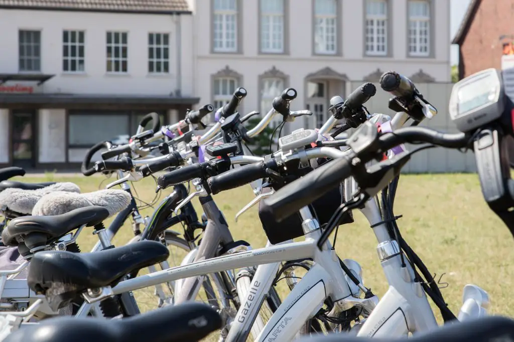 a row of electric commuter bikes parked up