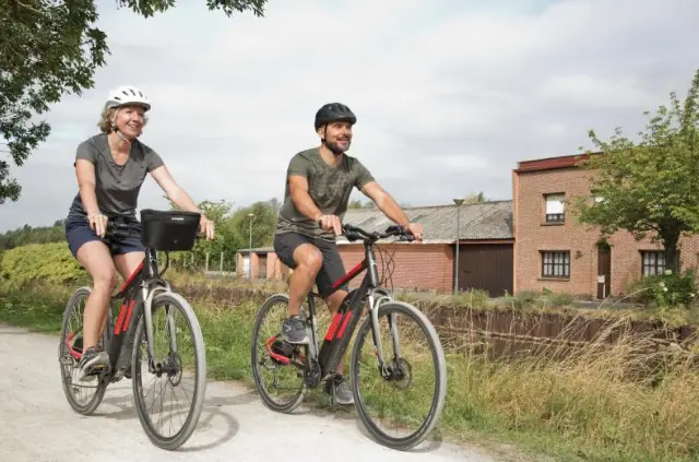 a couple riding electric bikes