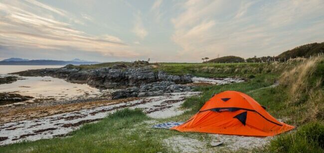 خيمة برتقالية بالقرب من الشاطئ